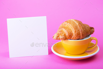 yellow cup on a pink background