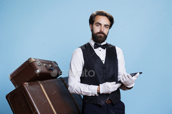 Hotel porter with tablet in hand