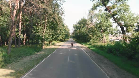 Woman riding on road bicycle training for race