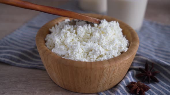 Traditional homemade cottage cheese in a wooden bowl Healthy and fermented food