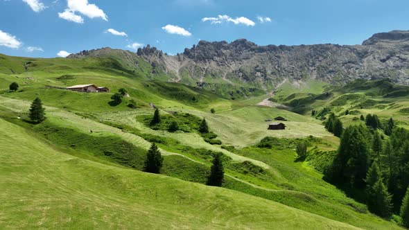 Dolomites Mountains with hiking paths and wooden cottages