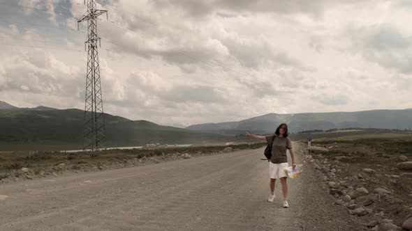 The girl is hitchhiking alone.