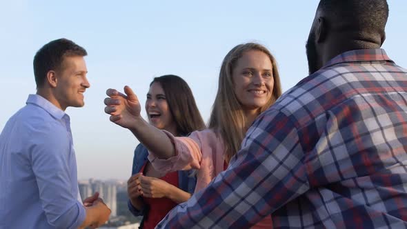 Happy Young People Talking and Hugging at Roof Party Slow-Mo, Friendship