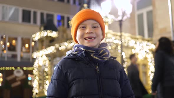 Young boy proudly presents his milk tooth gap alt