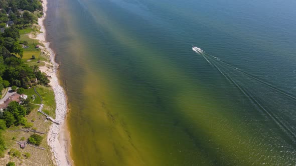 A boat sails along the coast in early Summer of 2020.