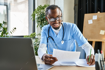 attractive cheerful african american doctor holding notes during online consultation, telemedicine