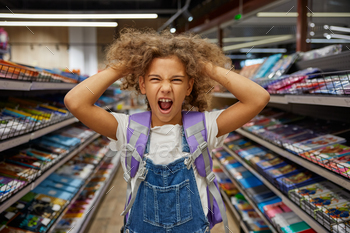 Stressed girl child feeling crazy during shopping at stationery shop