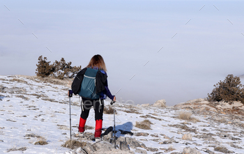 Woman hiking in snowy track.