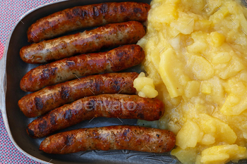 Close grilled Nuremberg sausages with potato