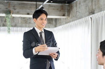 Businessmen answering questions at a meeting