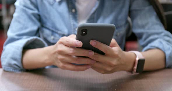 Woman touch on cellphone in restaurant