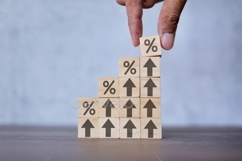 utting wooden cube block with icon percentage on top of arrow upward direction.