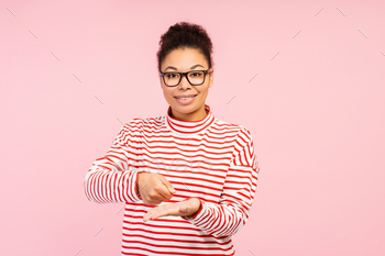 Attractive African American woman, translator wearing stylish eyeglasses speaking with sign language