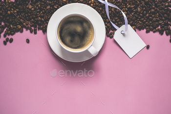 Pink vintage background With cup of coffee, coffee beans and tag