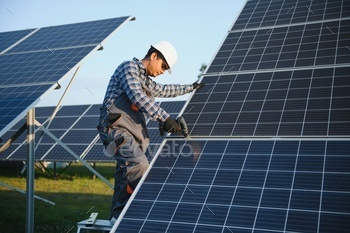 An Indian worker installs solar panels. The concept of renewable energy.