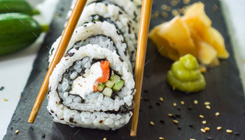 Sushi Roll Platter on dark plate. Salmon sushi set, serving food for restaurant, menu, advert or pac