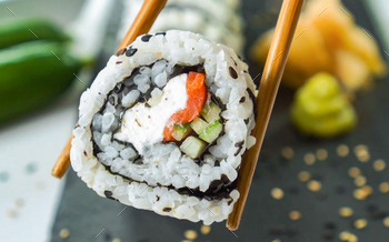 Sushi Roll Platter on dark plate. Salmon sushi set, serving food for restaurant, menu, advert or pac