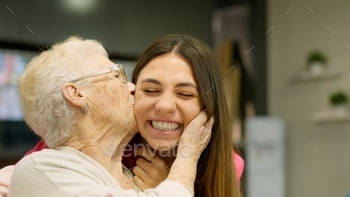 Endearing image of a grandmother kissing her granddaughter