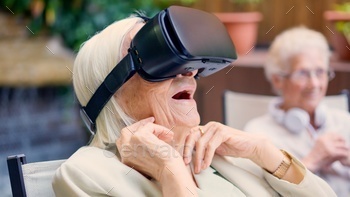 Shocked old woman using Virtual reality goggles in a geriatric