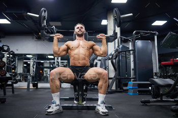 Muscular man exercising in gym.