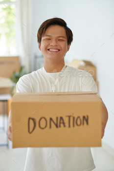Excited Volunteer Holding Box with Donations