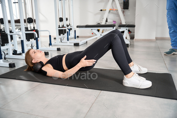 Female performs exercises on a mat