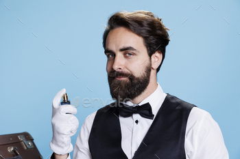 Rich elegant man spraying perfume