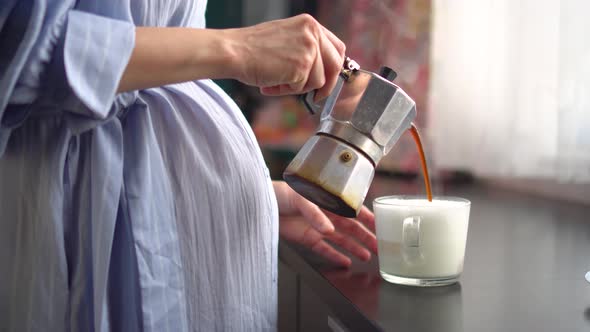 A Cute Pregnant Woman Pouring Coffee From Coffee Pot