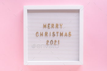 Letter board with Merry Christmas 2021 greeting, greeting quote on letterboard on pink pastel girly