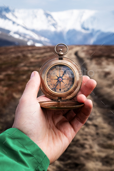 Retro compass in man hand