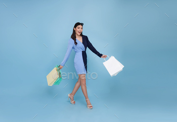 asian shopper woman enjoying shopping she is carrying shopping bags