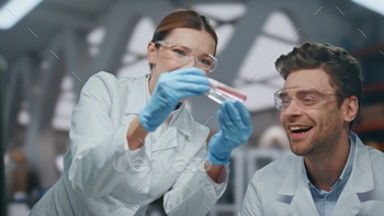 Successful doctors rejoicing research result discovering cure in lab close up.