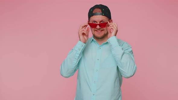 Playful Happy Man Wearing Sunglasses Blinking Eye Looking at Camera with Smile Winking Flirting