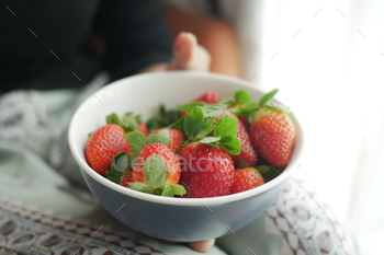 women holding a bowl of Ripe Red Strawberries
