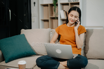 Female manager attending video conference and holding tablet, smartphone and  cup of coffee