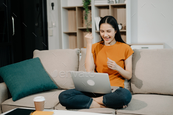 Female manager attending video conference and holding tablet, smartphone and  cup of coffee