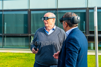Aged businessmen testing virtual reality headset outdoors