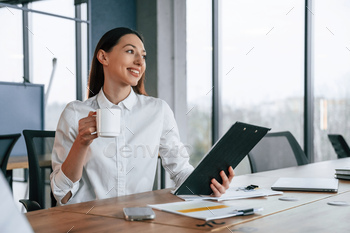 Businesswoman is indoors in the office