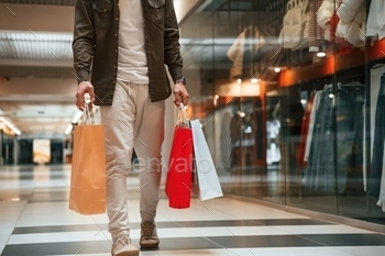 Close up view, holding shopping bags. Man is shopping in the supermarket