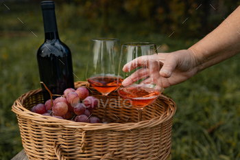 Take glass of wine. Two glass of tasty dry rose wine from ripe grapes with a bottle of wine on a