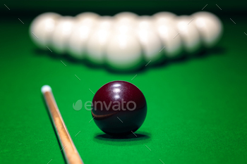 Ball is displayed on the pool table against the background of other balls and cue