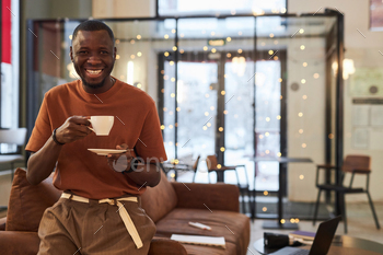 Black Man with Cup of Coffee in Coffee Shop