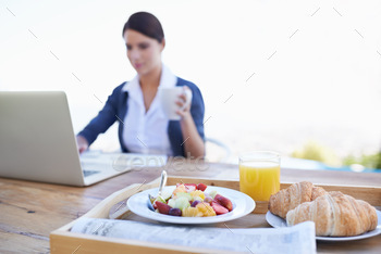 Checking her e-mails before breakfast