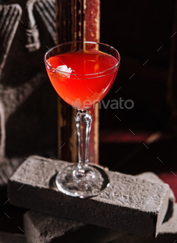 Italian cocktail with flower on gray stone