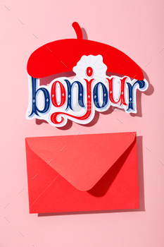 The word "bonjour" with a beret on a pink background.