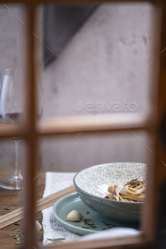 spaghetti dish behind a wood window