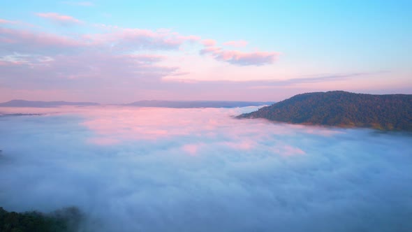 4K Aerial video Beautiful sunrise above dense clouds and fog in the morning