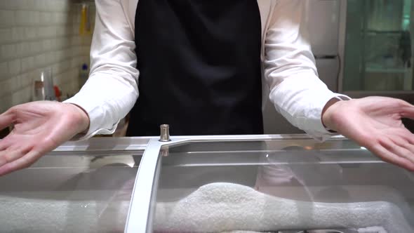 Bakery Café Shop Staff Giving Welcoming Hands Towards Viewer in Bakery Shop