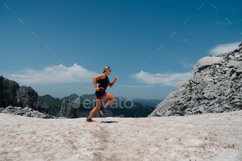 A fast skyrunner is achieving a goal and running an ultramarathon.