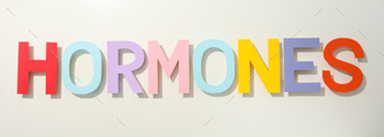 The word hormones on a light background.